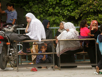 Palestinians sit inside the UNRWA school as they flee their houses following an Israeli ground offensive in Rafah in the southern Gaza Strip...