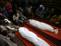 Palestinian mourners gather around the bodys, of Israeli bombardment during their funeral on July 18, 2014 in Rafah, in the southern Gaza St...