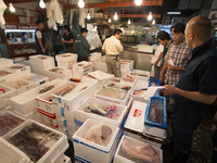 TOKYO, Japan A Tsukiji Fish Market employer serves a customer at Tsukiji Fish Market on july 7, 2014. The Tsukiji fish market located in Tok...