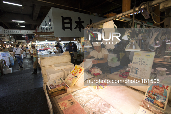TOKYO, Japan A Tsukiji Fish Employer sets fish as the customers are coming at Tsukiji Fish Market on july 7, 2014. The Tsukiji fish market l...
