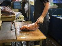 TOKYO, Japan A Tsukiji Fish Market employer cleans fish at Tsukiji Fish Market on july 7, 2014. The Tsukiji fish market located in Tokyo, ha...