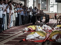 the bodies of kids during the funeral of eight members of Abu Jarad family who were killed overnight in an Israeli strike on July 19, 2014 i...