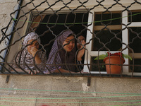 Palestinian relatives mourn, on objects during the funeral of nine people in Khan Yunis, in the southern Gaza Strip, on July 19, 2014. Israe...