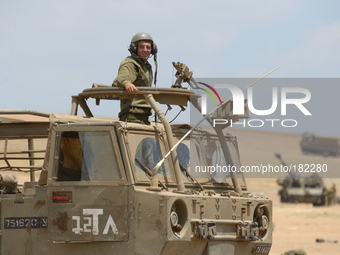 UNSPECIFIED, ISRAEL - JULY 19, 2014: An Israeli soldier stands atop an APC in an army deployment area near Israel's border with the Gaza Str...