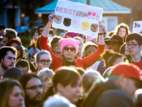 Kathleen Moyer, of NorthEast Philadelphia, holds up a sign as she stands in the crowd at Logan Square as hundreds take part in a Women's Str...