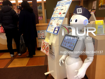 Pepper, a humanoid robot developed by SoftBank Group Corp., moves around on its own to guide passengers at sushi shop in Tokyo, Japan, March...