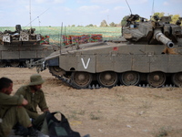 UNSPECIFIED, ISRAEL - JULY 19, 2014: IDF tanks in an army deployment area near Israel's border with the Gaza Strip, on July 19, 2014,  on th...