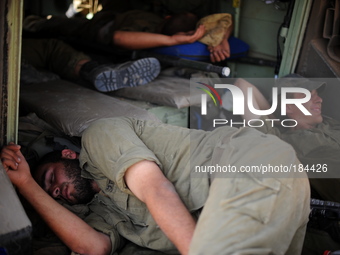 UNSPECIFIED, ISRAEL - JULY 19, 2014: Israeli soldiers sleep inside an APC in an army deployment area near Israel's border with the Gaza Stri...