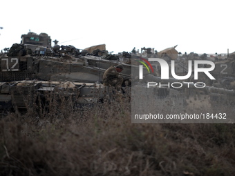 UNSPECIFIED, ISRAEL - JULY 19, 2014: An Israeli soldier sits on a tank in an army deployment area near Israel's border with the Gaza Strip,...