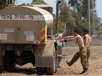 UNSPECIFIED, ISRAEL - JULY 19, 2014: Israeli soldiers are taking a field shower in an army deployment area near Israel's border with the Gaz...