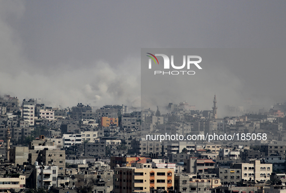 Smoke rises after Israeli shelling at Al Shejaiyaa neighbourhood in the east of Gaza City on 21 July 2014. Tens of thousand of Palestinians...