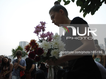 An unidentified Ukraine girl brings flowers during a special vigil for the passengers onboard the Malaysia Airline, MH17 in Kuala Lumpur, Ma...