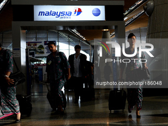 Malaysia Airlines flight crew arrives at Kuala Lumpur International Airport in Sepang, Malaysia, Friday, July 18, 2014. Ukraine said a passe...
