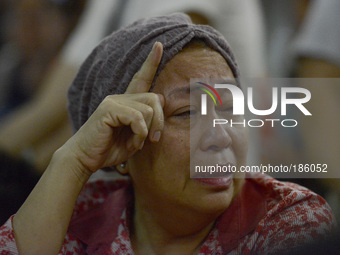 A family member of passenger onboard the ill fated Malaysia Airlines, MH17, weeps in Kuala Lumpur International Airport in Sepang, Malaysia,...