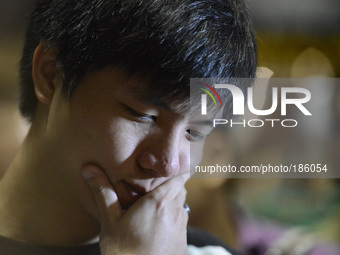 A family member of passenger onboard the ill fated Malaysia Airlines, MH17, reacts to questions from the media in Kuala Lumpur International...