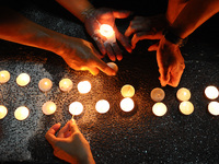 People arranges candles during a special vigil prayer for the ill fated Malaysia Airlines, MH17, in Kuala Lumpur, Malaysia, Tuesday, July 22...