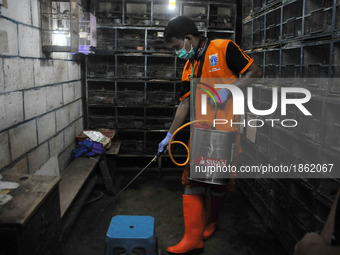 Officers of Marine Fisheries and Food Security spraying disinfectant in the barn where the bird traders at Pramuka market in Jakarta On Marc...