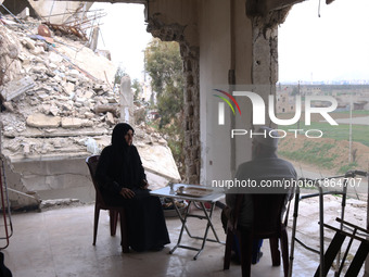 Syrian Umm Mohammed, and her husband drink coffee at their destroyed home in the rebel-held town of Douma, on the outskirts of the capital D...