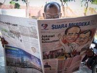 SEMARANG, INDONESIA - JULY 23: A man reads a newspaper carrying the front page headline on the victory of Indonesian Presidential Candidate...