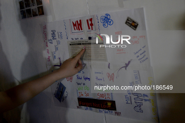 An unidentified man checks out a well wishes board for the ill fated Malaysia Airlines, MH17 in Kuala Lumpur, Malaysia, Tuesday, July 22, 20...