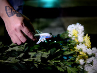 An unidentified man holds a toy plane during a special prayer vigil for the ill fated Malaysia Airlines, MH17 in Kuala Lumpur, Malaysia, Tue...