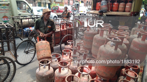A delivery man loding Liquid Petroleum Gas (LPG) cylinders at Central Kolkata in India ,Subsidised LPG cylinder price hiked by Rs5.57, ATF c...