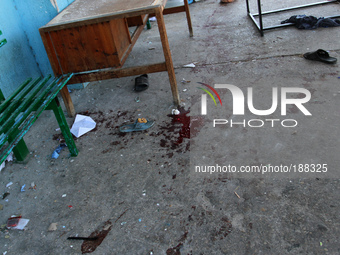 Blood is seen in the yard of a UN School in the northern Beit Hanun district of the Gaza Strip on July 24, 2014, after it was hit by an Isra...