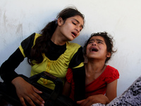 Palestinian girls cry after their father was killed in UN School in the northern Beit Hanun district of the Gaza Strip on July 24, 2014, aft...