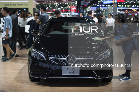 Workers clean a Mercedes Benz car at the 38th Bangkok International Motor Show in Bangkok, Thailand, on April 7, 2017. 