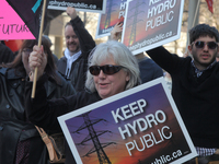 Rally to pressure the Ontario government to keep Hydro public and stop the privatization of Hydro One in downtown Toronto, Ontario, Canada,...