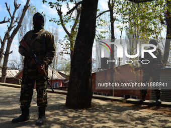  Indian Paramilitary force personals  stand guard outside a  polling station in central kashmir's Budgam district during By-Polls of Indian...