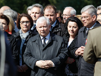 Conservative party leader and brother of late president Lech Kaczynski, Jaroslaw Kaczynski (c) is seen with PM Beata Szydlo at the military...