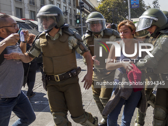 A woman is arrested by the riot police.
Thousands of students marched through the main avenue of Santiago, on April 11, 2017, demanding a f...