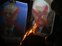 Palestinian youths burn a portrait of Palestinian leader Mahmud Abbas and a crossed poster depicting Prime Minister Rami Hamdallah during a...