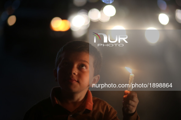 Palestinian boys hold candles during a protest against the blockade on Gaza, in Gaza City April 14, 2017. 
 