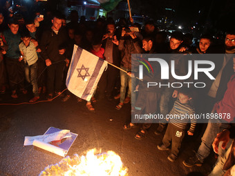Palestinian youths burn  burn an Israeli flag  during a protest against the Israeli blockade of the Gaza Strip on April 14, 2017, in in Gaza...