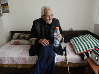 an elderly man with a bottle of clean water in the home for elderly people in Haskovo, Bulgaria, where near 156 elderly people live. Radiati...