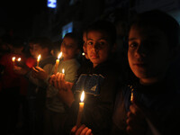 Palestinian boys hold candles during a protest against the blockade on Gaza, in Gaza City  on April 15, 2017.(