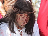 A participant playing the role of Jesus Christ during the Good Friday procession in Little Italy in Toronto, Ontario, Canada, on April 14, 2...