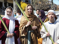 Children carrying a palm leaves during the Good Friday procession in Little Italy in Toronto, Ontario, Canada, on April 14, 2017. The Saint...
