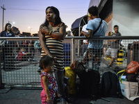 Ruth Jane Sombrio waits with packed bags at the seaport to leave by ferry to the province, in Manila, Philippines, March 31, 2017. President...