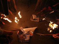  Hamas supporters burn a poster depicting Palestinian president Mahmoud Abbas during a protest against Gaza blockade and  protest of Abbas'...