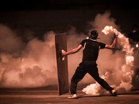 Bahrain , Abu Saiba - protester returning tear gas canister during the clashes with riot police , demonstration followed by clashes in Abu S...