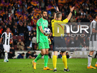 Gianluigi Buffon gives the ball to the referee Bjorn Kuipers at the end of the UEFA Champions League match between F.C. Barcelona v PSG, in...