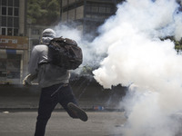 Demonstrators clash with police during a march against Venezuelan President Nicolas Maduro, in Caracas on April 19, 2017. Venezuelans took t...
