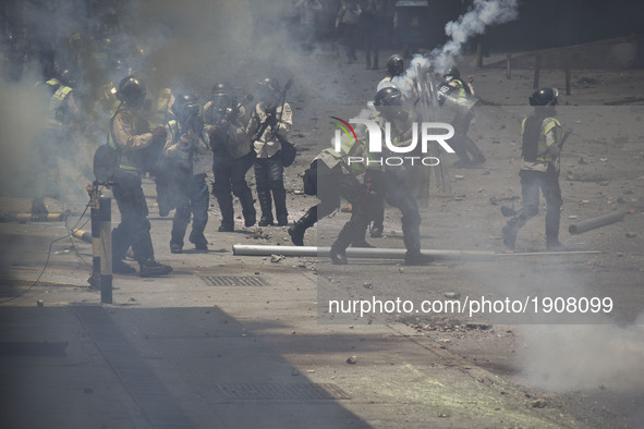 Demonstrators clash with police during a march against Venezuelan President Nicolas Maduro, in Caracas on April 19, 2017. Venezuelans took t...