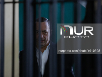 Ukrainian former lawmaker Mykola Martynenko, who is under investigation over the suspected embezzlement, is seen through the defendant's cag...