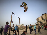 A palestinian youth practice his parkour skills in the beach of Gaza City during Sunset on April 21, 2017. (