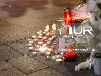  People bring flowers as they pay their respect at the site of a shooting on the Champs Elysees in Paris on April 21, 2017, a day after a gu...