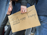 A woman attending the 'March for Science' holds a banner reading 'Truth over Trump' in Berlin, Germany on April 22, 2017. Thousands of peopl...